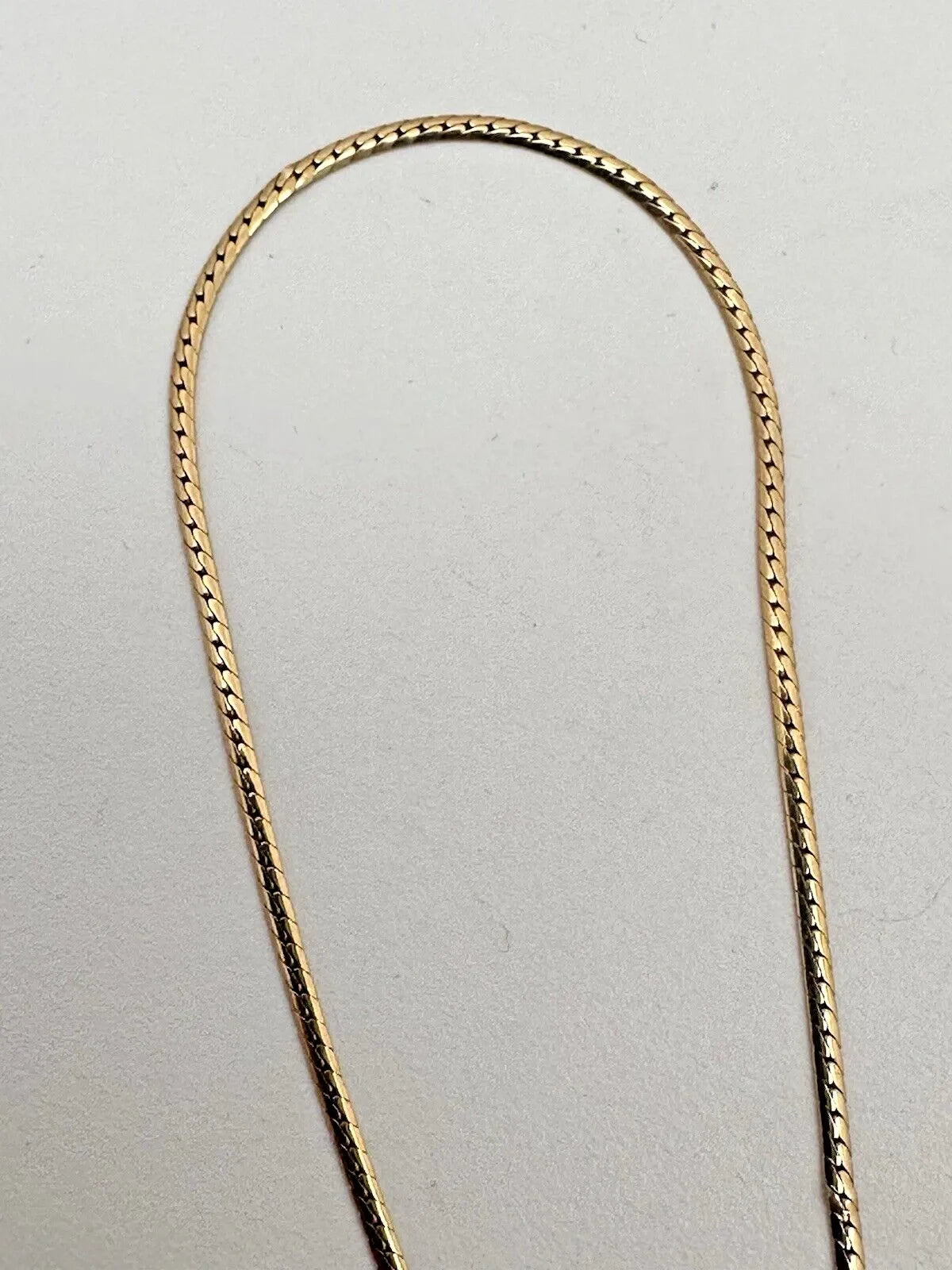 17-inch 14K yellow gold necklace, adorned with 7 oval 4 mm x 6 mm rubies and 3 round diamonds